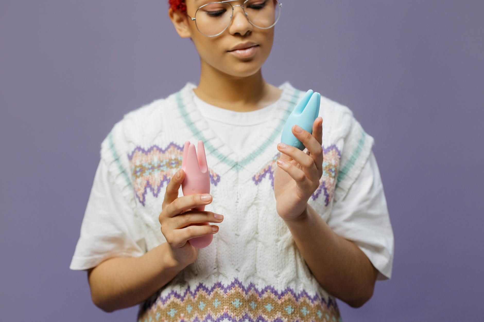Woman holding lemon clitoral vibrators while considering sensitivity changes from birth control