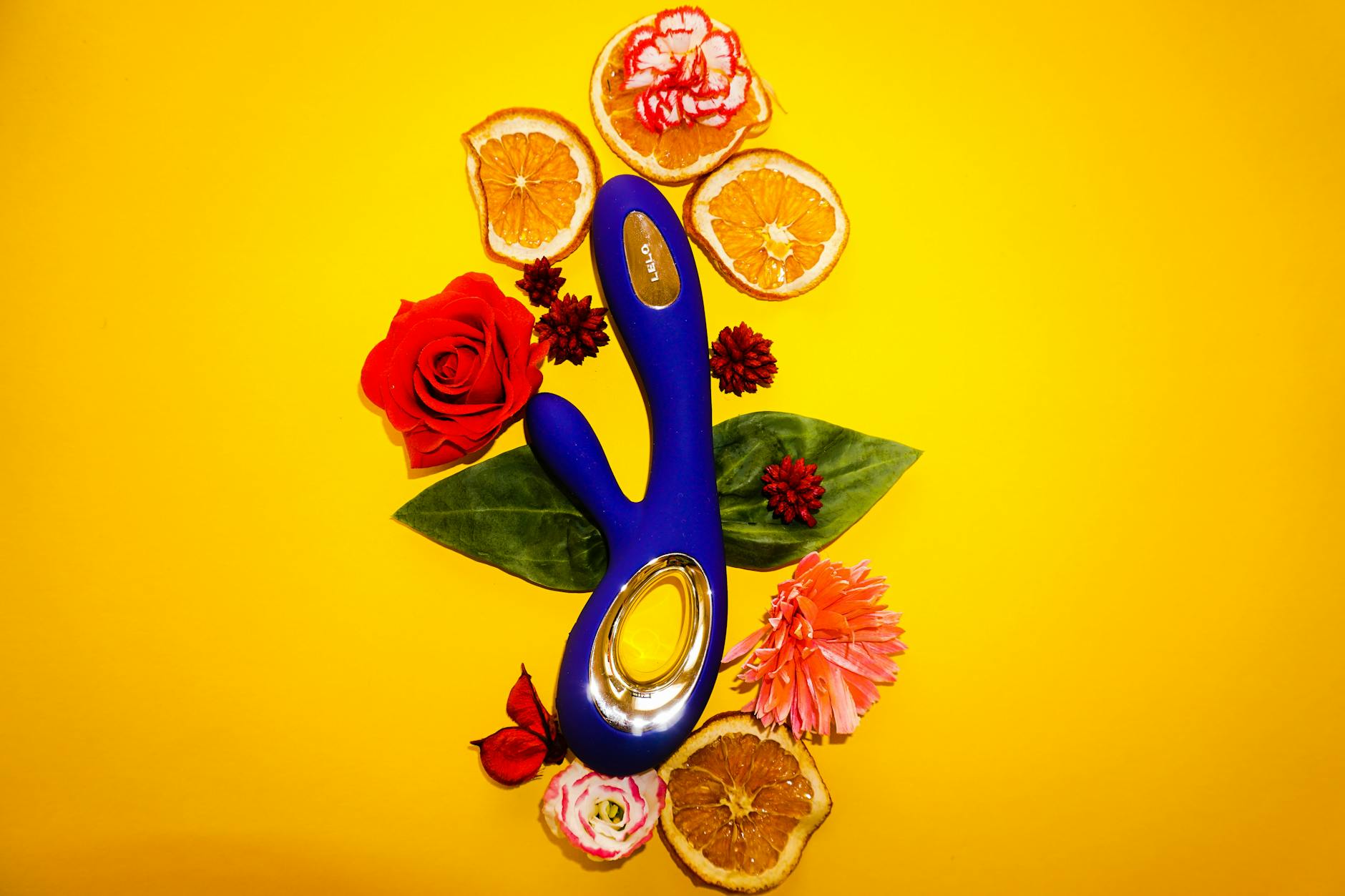 A blue silicone sex toy held in hand against a solid purple background, representing self-love and sexuality after illness recovery.